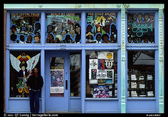 African-American man standing in front of blue storefront on Beal street. Memphis, Tennessee, USA (color)
