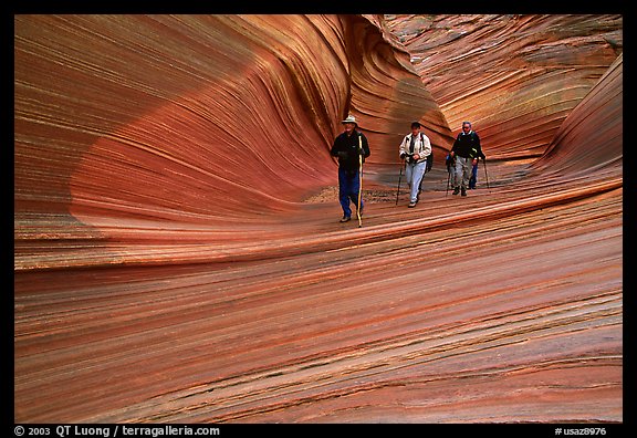 Hikers walk out of the Wave. Coyote Buttes, Vermilion cliffs National Monument, Arizona, USA