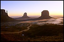 Mittens and fog, sunrise. Monument Valley Tribal Park, Navajo Nation, Arizona and Utah, USA