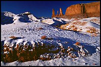 Snow on the floor, with Three Sisters in the background. Monument Valley Tribal Park, Navajo Nation, Arizona and Utah, USA
