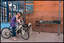 Girls on bikes and puppy parking. Telluride, Colorado, USA