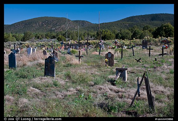 Headstones in grassy area, cemetery, Picuris Pueblo. New Mexico, USA (color)
