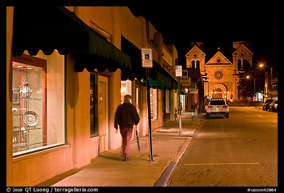 Man walking gallery and St Francis by night. Santa Fe, New Mexico, USA