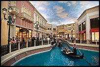 Gondolas and Grand Canal bordered by shops in the Venetian casino. Las Vegas, Nevada, USA