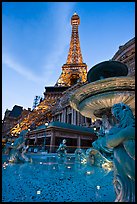Fountain and Eiffel Tower replica at dusk, Paris casino. Las Vegas, Nevada, USA