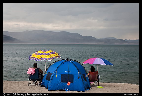 People with tent and beach umbrellas, approaching storm. Pyramid Lake, Nevada, USA (color)