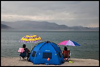 People with tent and beach umbrellas, approaching storm. Pyramid Lake, Nevada, USA ( color)