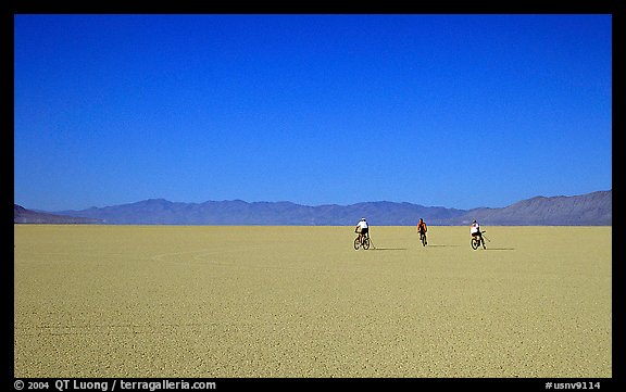 Three bicyclists on the desert Playa, Black Rock Desert. Nevada, USA (color)