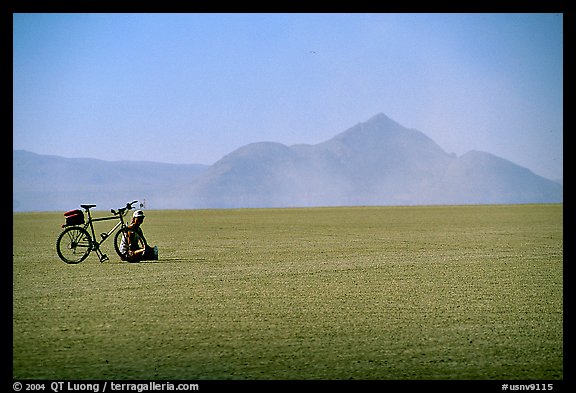 Bicyclist on the desert Playa, Black Rock Desert. Nevada, USA (color)