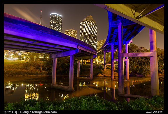 Skyline from under highway bridges at night. Houston, Texas, USA (color)