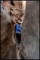 Woman squeezing in Zebra Slot Canyon. Grand Staircase Escalante National Monument, Utah, USA ( color)