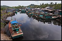 Fishing boats along dark river. Phu Quoc Island, Vietnam (color)