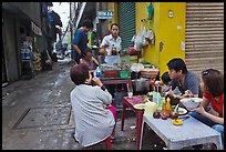 Breakfast at food stall in alley. Ho Chi Minh City, Vietnam ( color)
