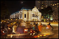 Motorbikes and colonial-area Opera House at night. Ho Chi Minh City, Vietnam
