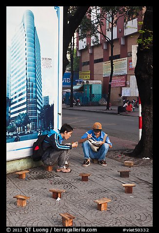 Men having breakfast on a sidewalk. Ho Chi Minh City, Vietnam