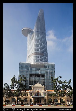 Bitexco Tower (tallest in the city) dwarfing colonial-area building. Ho Chi Minh City, Vietnam (color)