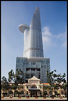 Bitexco Tower (tallest in the city) dwarfing colonial-area building. Ho Chi Minh City, Vietnam (color)