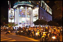 Dense motorcycle traffic in front of Saigon Center at night. Ho Chi Minh City, Vietnam