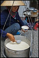 Woman serving a bowl of soft tofu. Ho Chi Minh City, Vietnam