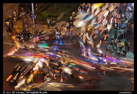 Long exposure traffic trails on busy intersection from above at night. Ho Chi Minh City, Vietnam