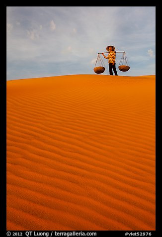 Woman on top of dune field. Mui Ne, Vietnam