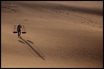 Shadows of woman on dune field. Mui Ne, Vietnam ( color)