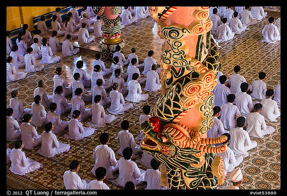 Column and worshippers, Cao Dai Holy See temple. Tay Ninh, Vietnam (color)