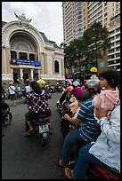 Family on motorbike watching performance at opera house. Ho Chi Minh City, Vietnam ( color)