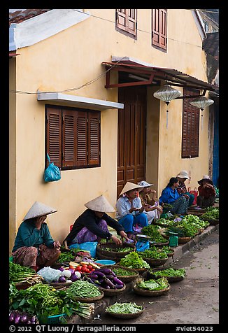 Vegetable vendors sitting in front of old house. Hoi An, Vietnam (color)