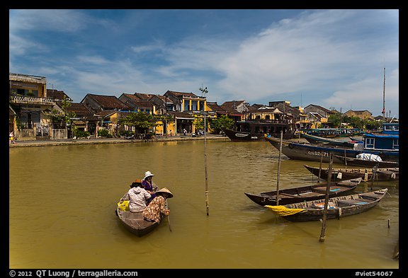 Women crossing the Thu Bon River in a rowboat. Hoi An, Vietnam (color)