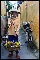 Fruit vendor carrying bananas. Hoi An, Vietnam ( color)