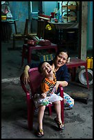 Boy and woman in kitchen. Hoi An, Vietnam (color)