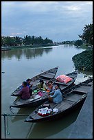 Family having dinner on boats at dusk. Hoi An, Vietnam (color)