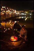 Woman selling candle lanterns by the bridge. Hoi An, Vietnam ( color)