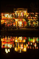 Waterfront house reflected in river at night. Hoi An, Vietnam (color)