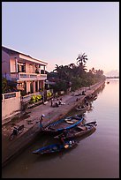 Waterfront and quay with vendors at sunrise. Hoi An, Vietnam (color)