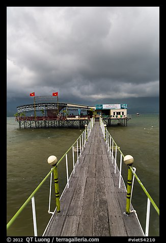 Boarwal, offshore restaurant, and threatening clouds. Vietnam