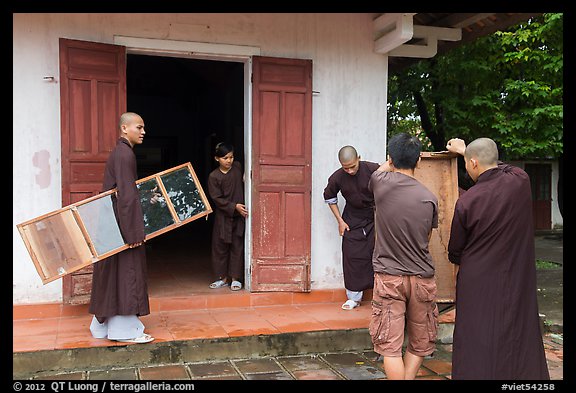Monks carrying furniture, Thien Mu pagoda. Hue, Vietnam