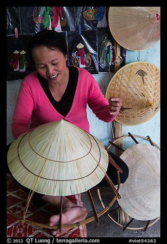 Woman crafting conical hat. Hue, Vietnam (color)