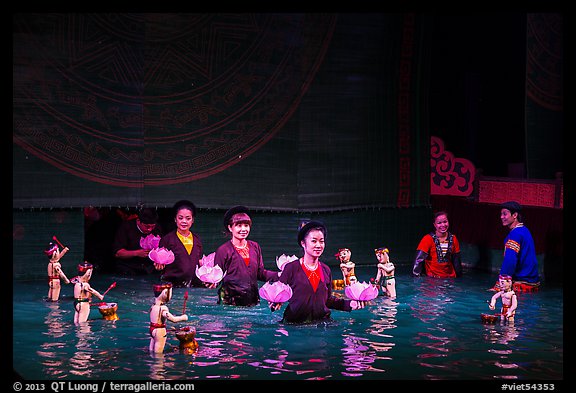 Puppeters coming from behind the bamboo screen after performance, Thang Long Theatre. Hanoi, Vietnam (color)