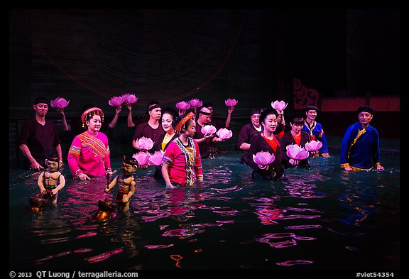 Water puppet artists standing in pool after performance, Thang Long Theatre. Hanoi, Vietnam (color)