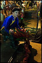 Water puppet artist holding dragon backstage, Thang Long Theatre. Hanoi, Vietnam (color)