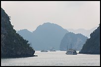 Tour boats and islands in mist. Halong Bay, Vietnam ( color)