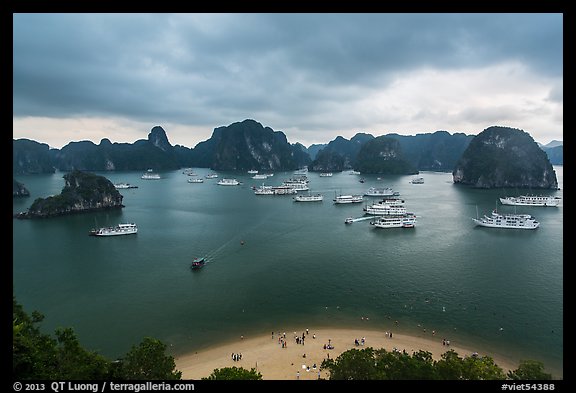 Crescent beach, boats and karst, Titov Island. Halong Bay, Vietnam