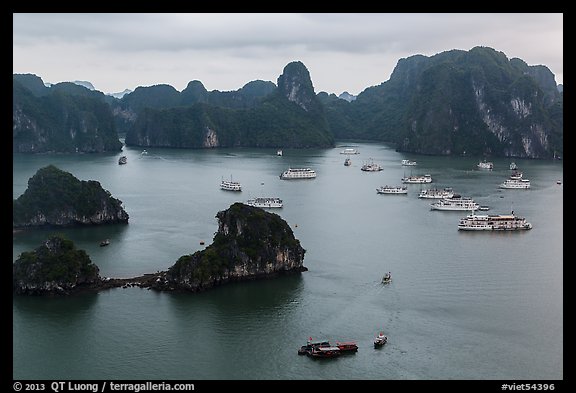 White tour boats and limestone islands covered in tropical vegetation. Halong Bay, Vietnam