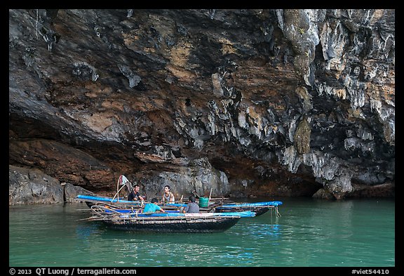 Fishermen anchor in cave for breakfast. Halong Bay, Vietnam (color)