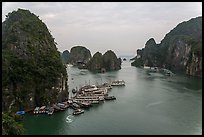 Tour boats anchored at base of island. Halong Bay, Vietnam (color)