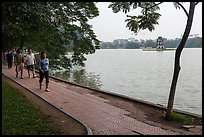 Walking for exercise around Hoang Kiem Lake at dawn. Hanoi, Vietnam (color)
