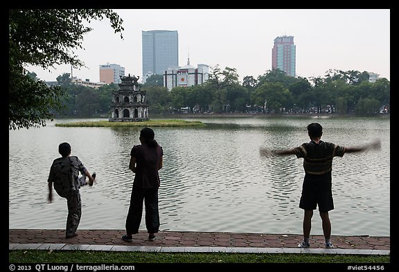 People exercising in front of Turtle Tower, Hoang Kiem Lake. Hanoi, Vietnam