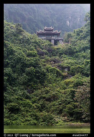 Temple perched on lush hill, Trang An. Ninh Binh,  Vietnam (color)